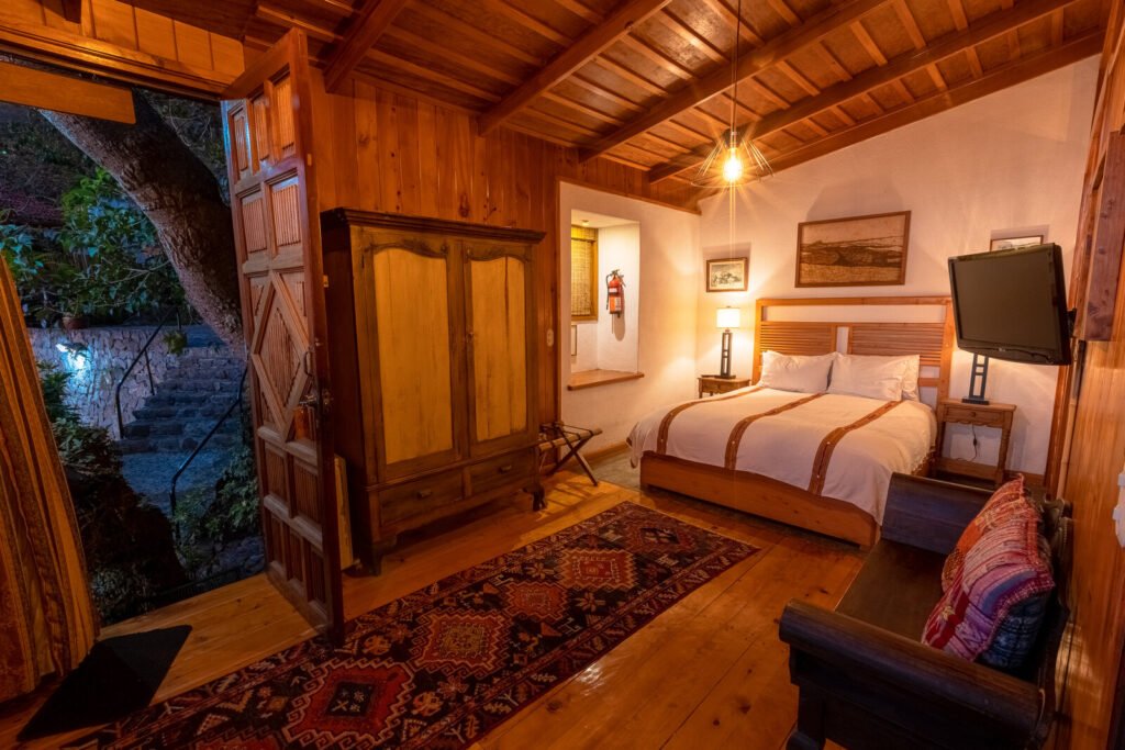 Villa Jade bedroom with wooden decor, king bed, and outdoor access