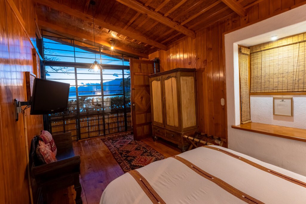 Villa Jade bedroom with lake view and rustic wooden decor