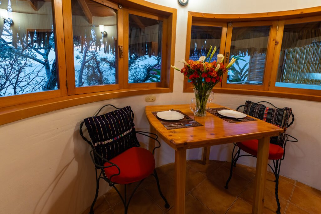 Villa Loft dining nook with table, chairs, and floral centerpiece.