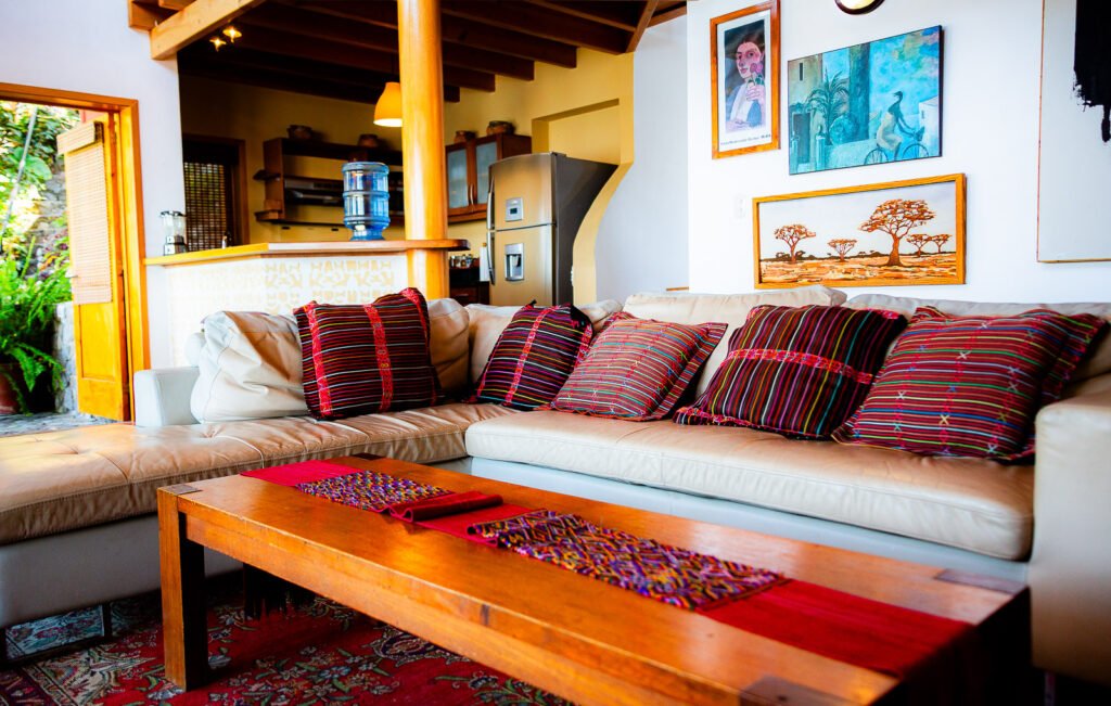 Villa Mirador living room with a large sectional sofa, colorful pillows, and a wooden coffee table.