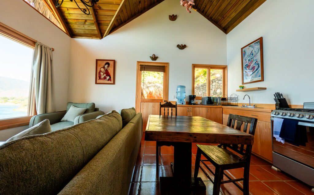 Villa Shakti interior: cozy living space with kitchen, dining table, and comfortable sofa.